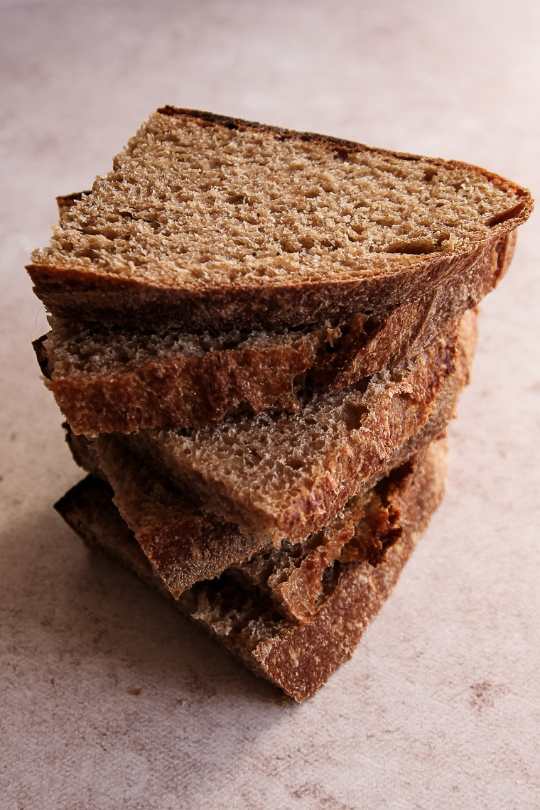 a stack of whole wheat sourdough bread slices