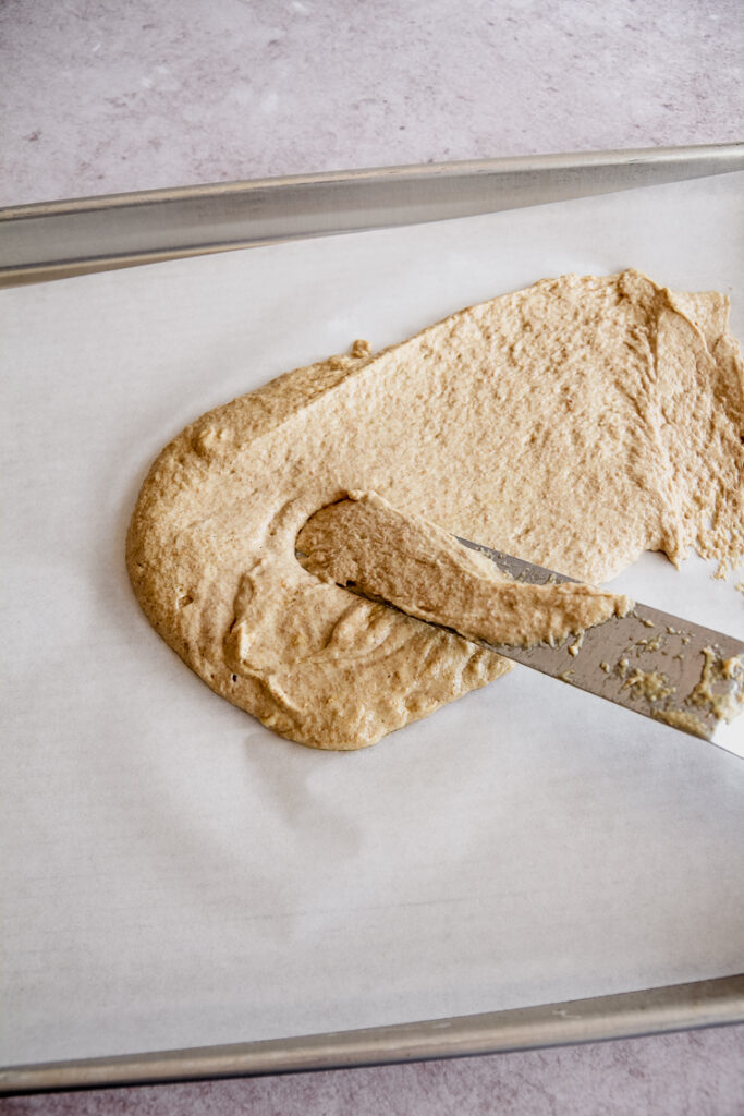 Divide whole grain cracker batter between to half sheet pans